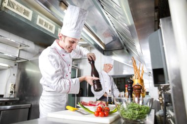 Şef restoranın mutfağında yemek hazırlıyor..