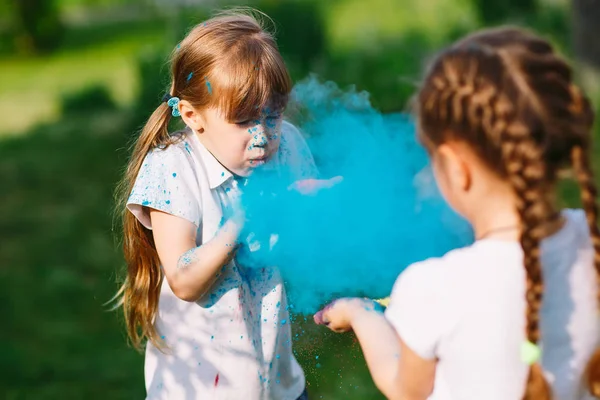 Cute european child girls celebrate Indian holi festival with colorful paint powder on faces and body. — Stock Photo, Image