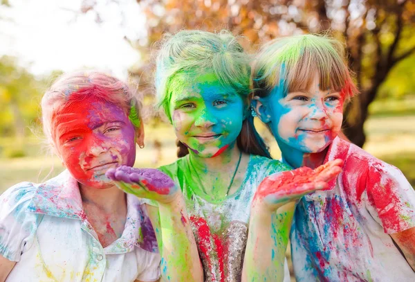 Cute european child girls celebrate Indian holi festival with colorful paint powder on faces and body — Stock Photo, Image