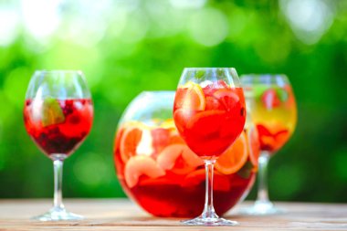 Yaz kokteyli. Yeşil arka planda meyve kokteyli. Narenciye, çilek, çilek, yaban mersini, nane, buz