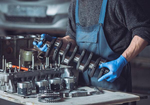 Master collects a rebuilt motor for the car