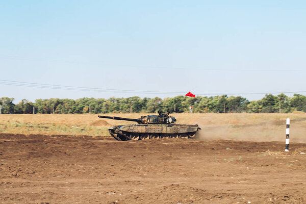 Armored Tank rides on off-road. Tank exercises in the countryside.
