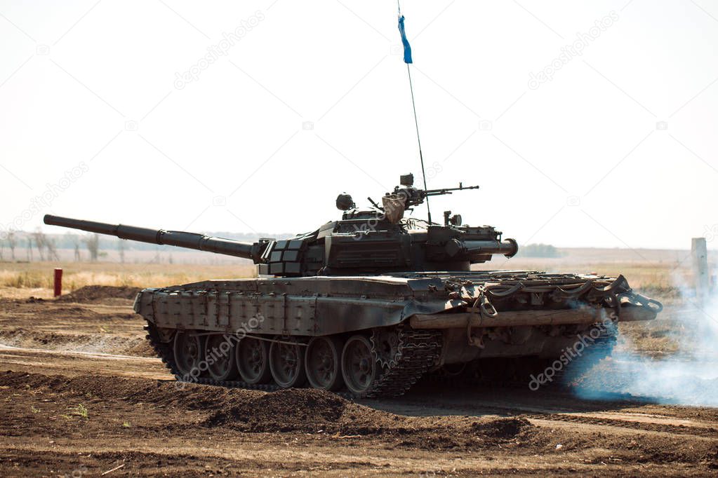 Armored Tank rides on off-road. Tank exercises in the countryside.