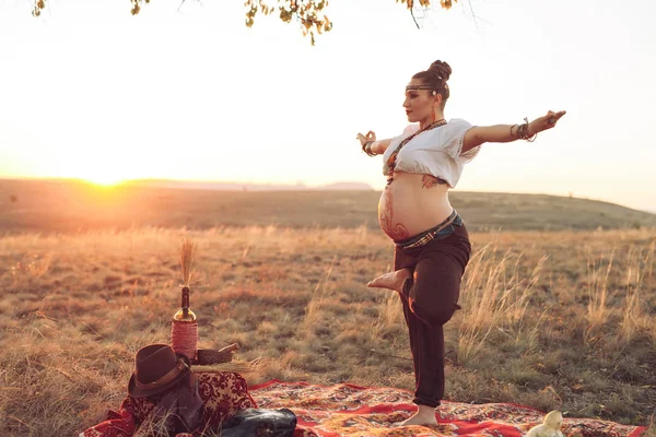 해질 녘에 들판에서 요가를 하는 임신부 — 스톡 사진
