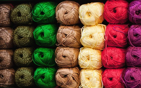 Colorful threads. Selection of colorful yarn wool on shopfront. Knitting background, a lot of balls. Knitting yarn for handmade winter clothes. — Stock Photo, Image