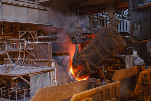 smelting of the metal in the foundry, Factory worker takes a sample for metal.