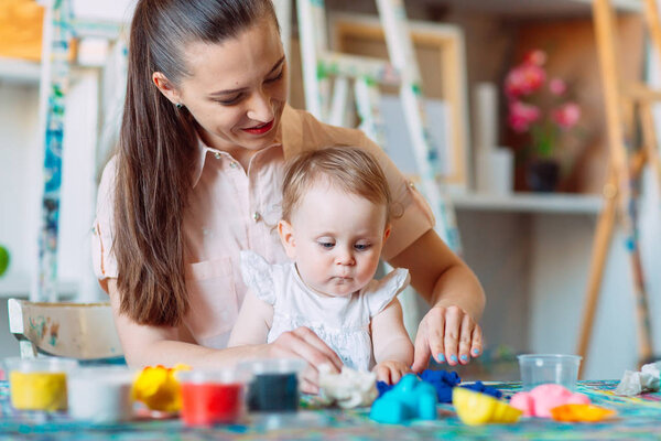 Mother and daughter playing with the kinetic sand.