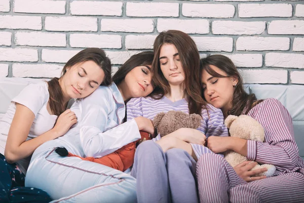 Sleeping group of young people in a bad. — Stock Photo, Image