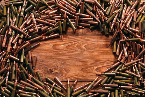 Different ammo on wooden background. Weapon concept — Stock Photo, Image