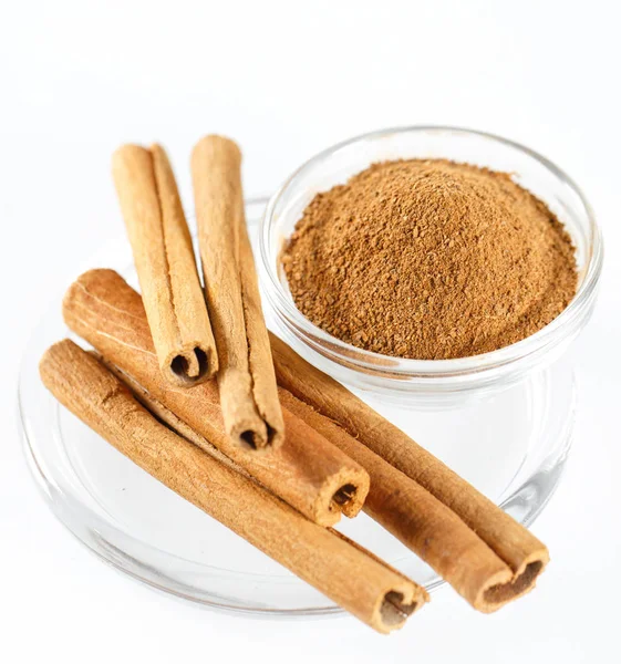 Cinnamon Isolated on the white background in a plate. — Stock Photo, Image