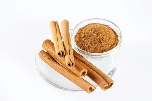 Cinnamon Isolated on the white background in a plate. — Stock Photo, Image