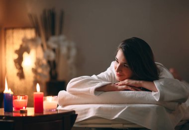Spa, masaj. Genç, siyah saçlı güzel bir kız masaj bekliyor..