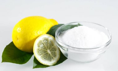 Beyaz arka planda limon asidi ve limon meyvesi.