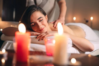 Spa, masaj. Genç siyah saçlı güzel kız masaj yapıyor..