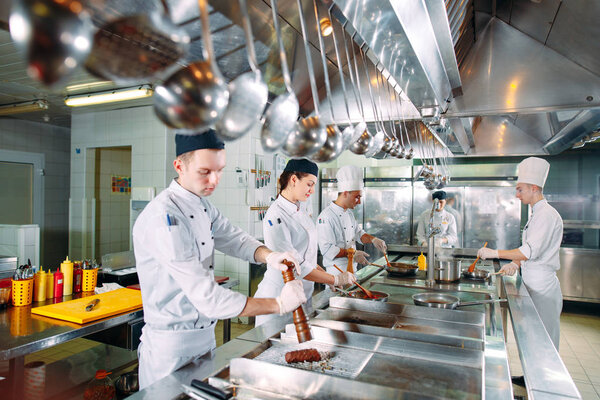 Modern kitchen. The chefs prepare meals in the restaurants kitchen