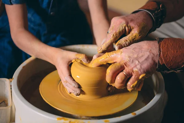 Pottery workshop. Grandpa teaches granddaughter pottery. Clay modeling