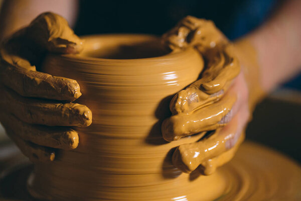 Pottery workshop. A little girl makes a vase of clay. Clay modeling