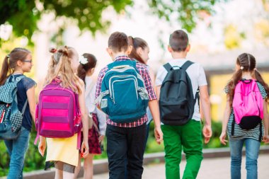 Group of kids going to school together. clipart