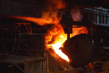 smelting of the metal in the foundry on the factory clipart