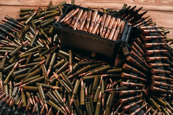 A lot of different ammo on a wooden background. — Stock Photo, Image