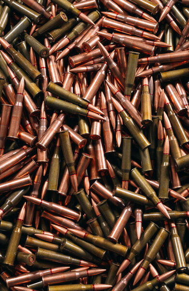 A lot of different ammo on a wooden background.