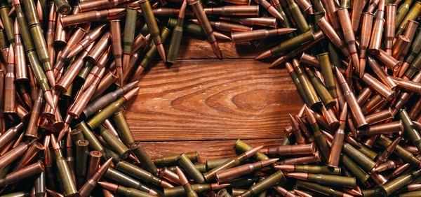 A lot of different ammo on a wooden background. — Stock Photo, Image