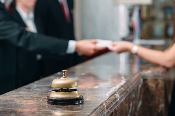 Picture of guests getting key card in hotel.