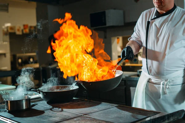 Cocina moderna. Los cocineros preparan comidas en la estufa en la cocina del restaurante u hotel. El fuego en la cocina. — Foto de Stock