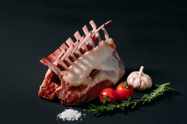 A rack of new Zealand Lamb in raw form on a black background. clipart