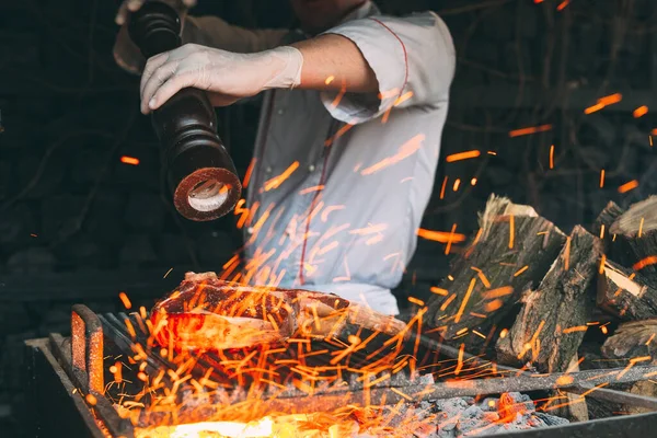 Šéfkuchař peč steak na ohni. — Stock fotografie