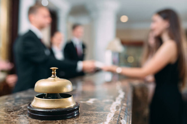 Picture of guests getting key card in hotel.