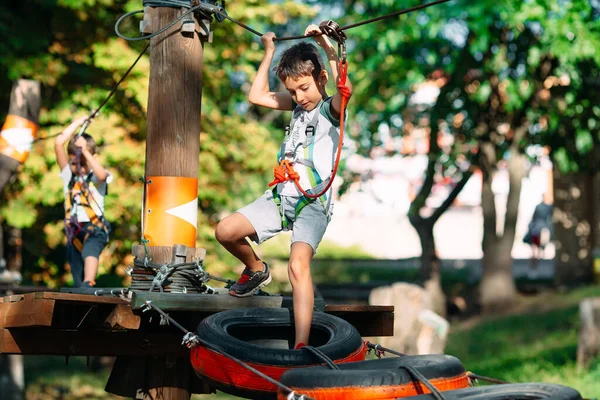 Park linowy. Dzieciak pokonuje przeszkodę w parku linowym.. — Zdjęcie stockowe