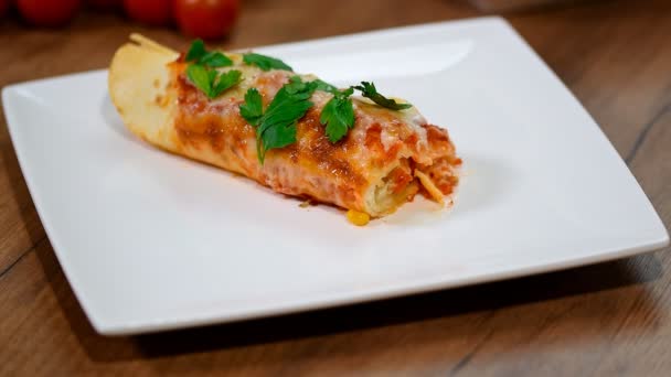 Traditional mexican enchiladas with chicken meat, spicy tomato sauce and cheese on a plate. Mexican cuisine. — Stock Video