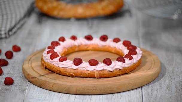 Choux pastry eclair cake Paris Brest with raspberry. — Stock Video