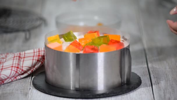 Making cake with colorful fruity jelly pieces. — Stock Video