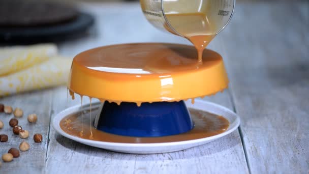 K nepoznání cukrář pokrývá upečený dort s karamelovou zasklení. Proces přípravy lahodný dezert. — Stock video