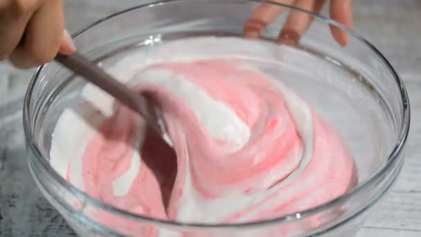 Женщина перемешивает лопатку с ягодным муссом. Делать торт из мусса . — стоковое видео