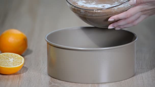Cake batter pouring into baking dish. Home baking. Woman pour dough into round baking pan. — Stock Video