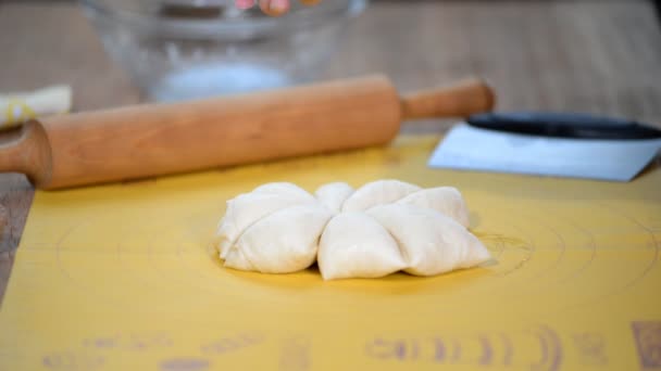 Woman hands rolls Bread Rolls dough. Girls hands kneading dough in flour on table — Stock Video