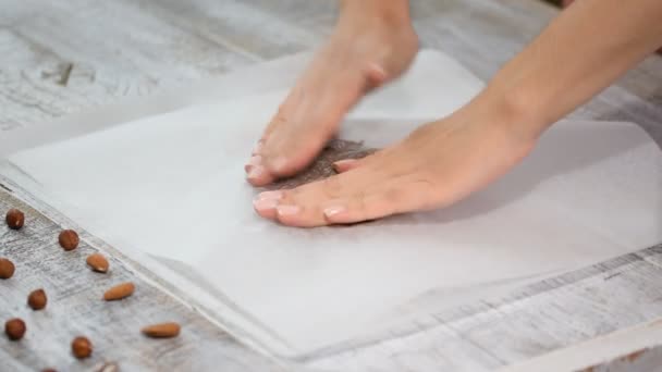 Roll out dough between two layers of baking parchment. — Stock Video