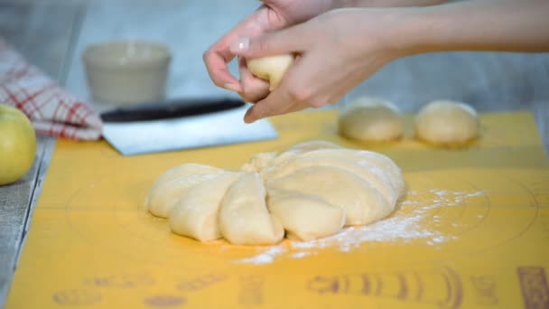 Kvinna baker skärande rå deg rulla i bitar på tabellen med mjöl. — Stockvideo