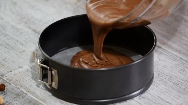 Pouring chocolate cake batter into the baking form. Making Chocolate Brownie. — Stock Video