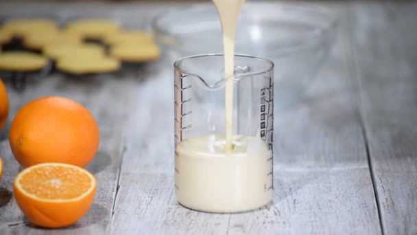 Woman Pours Vanilla Mousse Into Glass Measuring Cup. — Stock Video