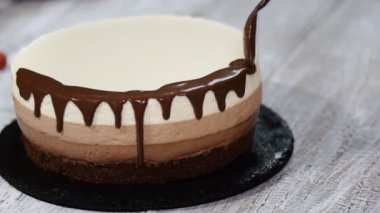Üç Kişilik çikolatalı mousse kek süslemeleri ile eritilmiş çikolata.
