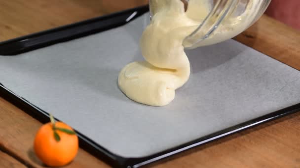 Pouring cake batter onto baking sheet. — Stock Video