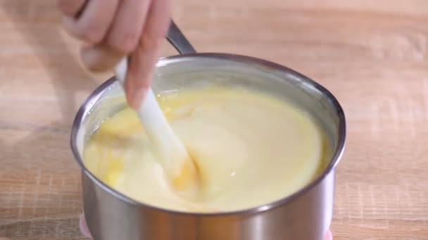 Femme remuer la crème dans la casserole — Video
