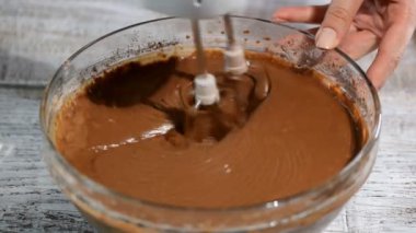 Mikser kırbaçlanan çikolatalı hamur. Kakao tozu, un ve dövülmüş yumurta karıştırma. Çikolata katman kek yapmak. Serisi.