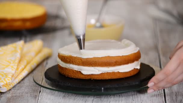 Pastry chef in the kitchen decorating a cake. Making cake with pineapple filling. — Stock Video