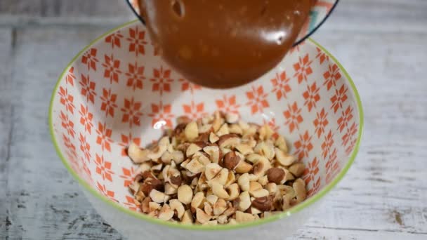 Stirring caramel hazelnuts filling. Making cake filling — Stock Video