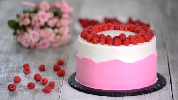 Cocinero pastelero en la cocina decorando un pastel con frambuesas — Vídeos de Stock